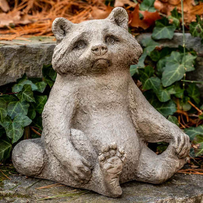 Campania International Ricky Racoon Statue, set in the garden to add charm and character. The statue is shown in the Brownstone Patina.