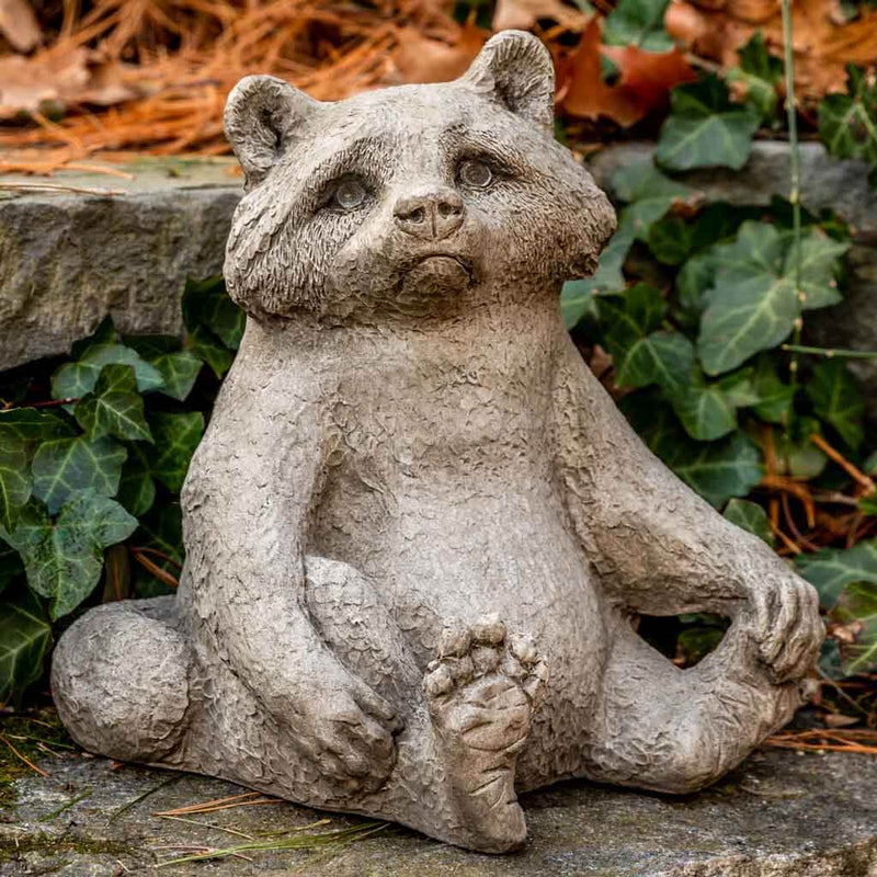 Campania International Ricky Racoon Statue, set in the garden to add charm and character. The statue is shown in the Brownstone Patina.