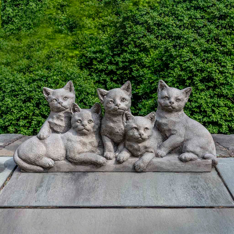 Campania International Quintuplets Statue, set in the garden to add charm and character. The statue is shown in the Greystone Patina.