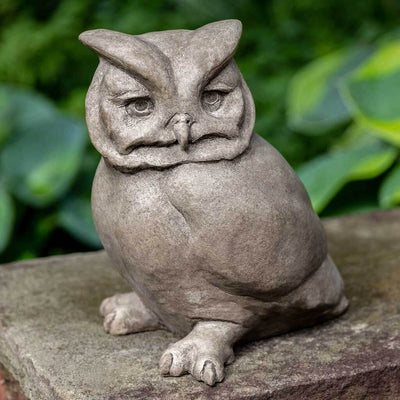 Campania International Hoot Owl Statue, set in the garden to add charm and character. The statue is shown in the Greystone Patina.