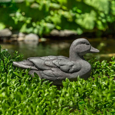 Campania International Decoy Duck Statue, set in the garden to add charm and character. The statue is shown in the Greystone Patina.