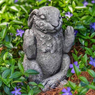 Campania International Meditation Bunny Statue, set in the garden to add charm and character. The statue is shown in the Greystone Patina.