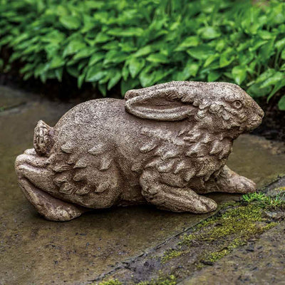Campania International Meadow Rabbit Statue, set in the garden to add charm and character. The statue is shown in the Browstone Patina.