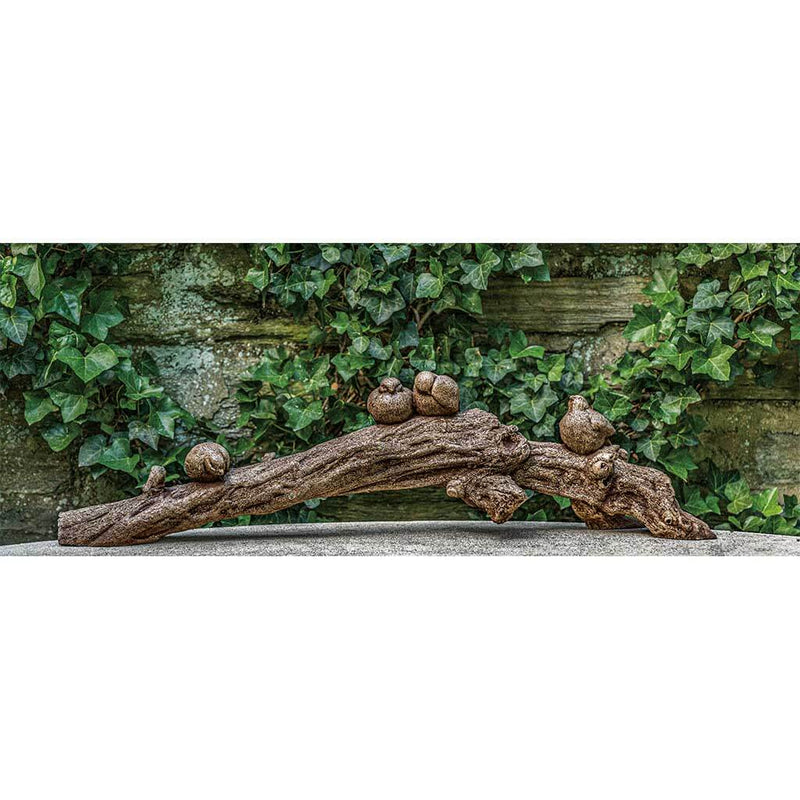 Campania International Birds on a Branch Statue, set in the garden to add charm and character. The statue is shown in the Brown Stone Patina.