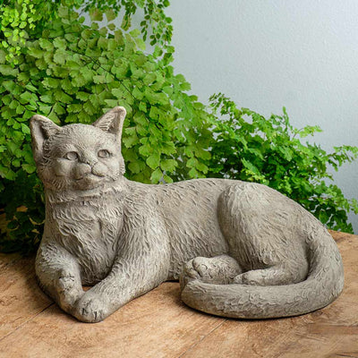 Campania International Camilla Statue, set in the garden to add charm and character. The statue is shown in the Alpine Stone Patina.
