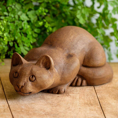 Campania International Folk Art Cat Statue, set in the garden to add charm and character. The statue is shown in the Pietra Nuova Patina.