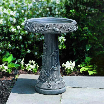 Campania International Hummingbird Birdbath, shown in the Alpine Stone color, highlighting and enriching the details of the cast stone.