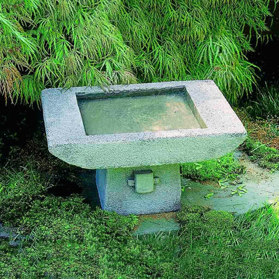Campania International Kyoto Birdbath, shown in the Alpine Stone color, highlighting and enriching the details of the cast stone.