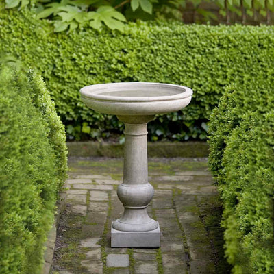 Campania International Williamsburg Tea Table Birdbath, set in the garden to adding charm and purpose. The birdbath is shown in the Verde Patina.