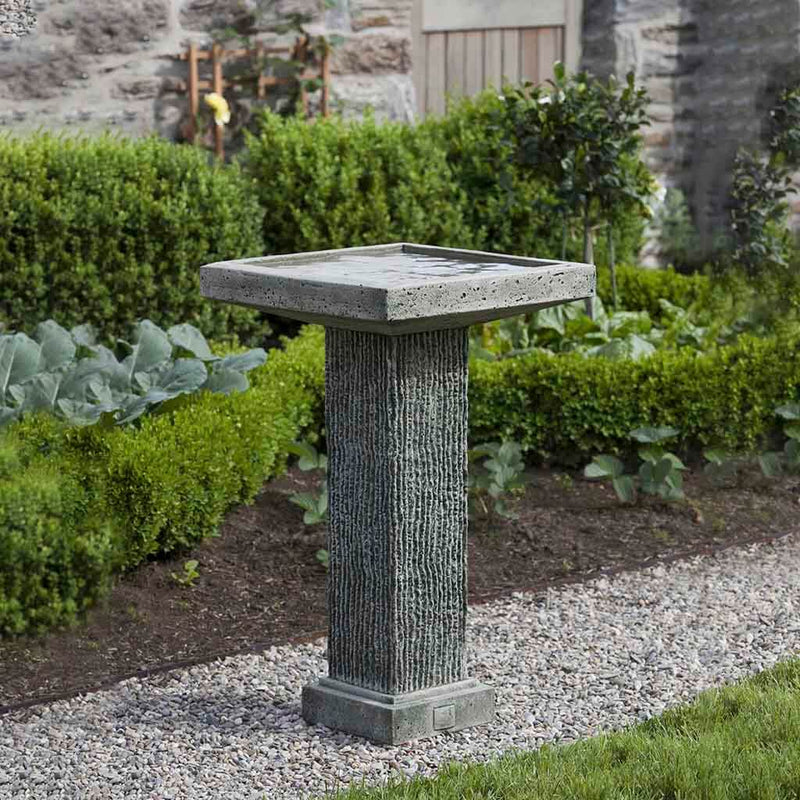 Campania International Reef Point Birdbath, set in the garden to adding charm and purpose. The birdbath is shown in the Alpine Stone Patina.