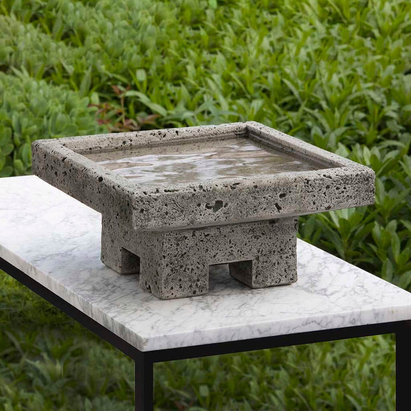 Campania International Kosei Birdbath, shown in the Alpine Stone color, highlighting and enriching the details of the cast stone.