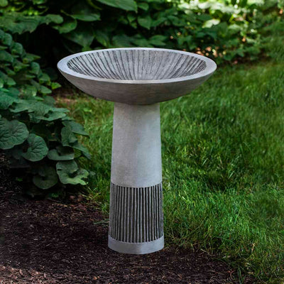 Campania International Equinox Birdbath, shown in the Alpine Stone color, highlighting and enriching the details of the cast stone.