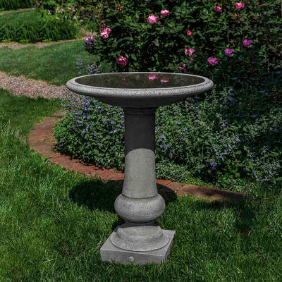Campania International Williamsburg Boxwood Birdbath, set in the garden to adding charm and purpose. The birdbath is shown in the Alpine Stone Patina.