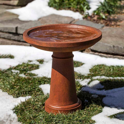 Campania International Sunbury Birdbath, set in the garden to adding charm and purpose. The birdbath is shown in the Ferro Rustico Nuovo Patina.