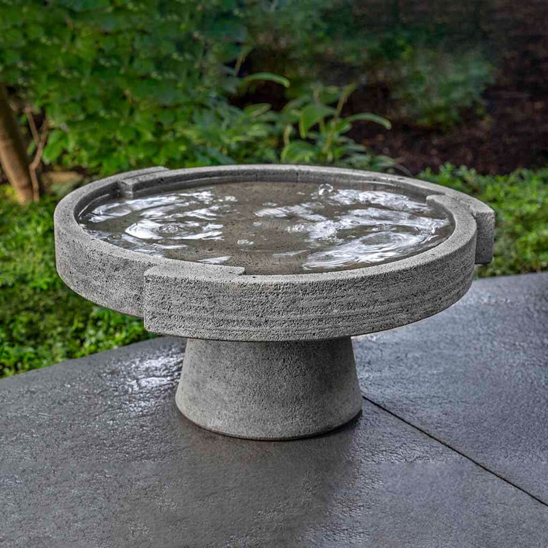 Campania International Low Concept Birdbath, shown in the Alpine Stone color, highlighting and enriching the details of the cast stone.