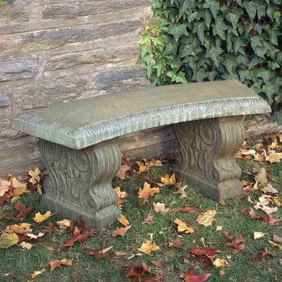 Campania International Traditional Curved Garden Bench, set in the garden to adding charm and purpose. The bench is shown in the Copper Bronze Patina.