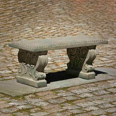 Campania International Classic Garden Bench, set in the garden to adding charm and purpose. The bench is shown in the Alpine Stone Patina.