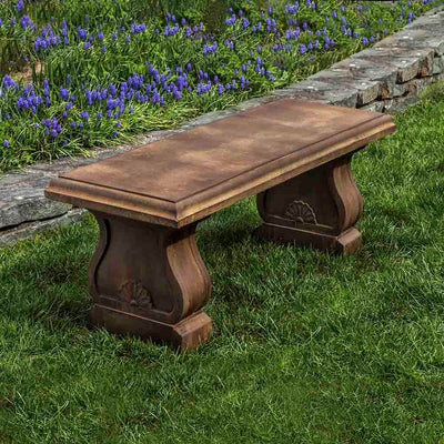 Campania International Westland Bench, set in the garden to adding charm and purpose. The bench is shown in the Pietra Nuovo Patina.