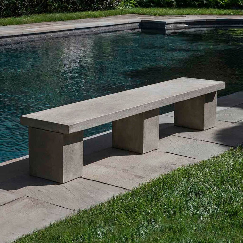 Campania Internatonal Biscayne Bench, set in the garden to adding charm and purpose. The bench is shown in the Verde Patina.