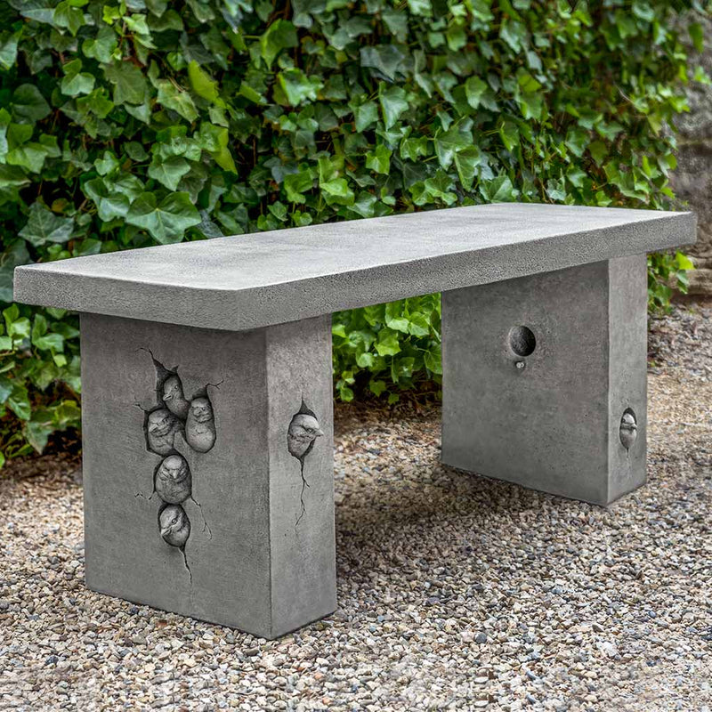 Campania Internatonal Birdhouse Bench, set in the garden to adding charm and purpose. The bench is shown in the Alpine Stone Patina.