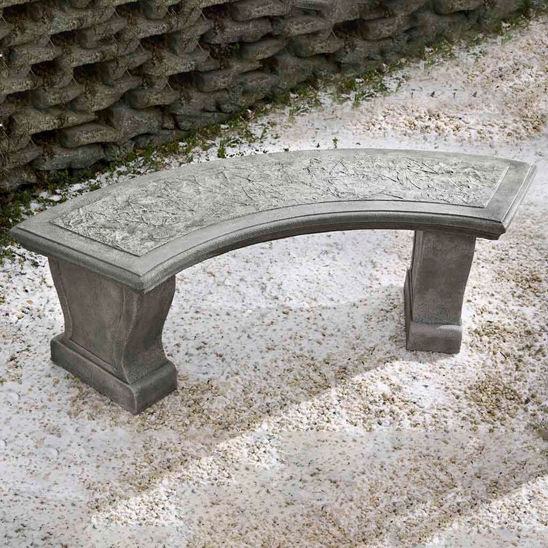 Campania International Curved Leaf Bench, shown in the Alpine Stone color, highlighting and enriching the details of the cast stone.