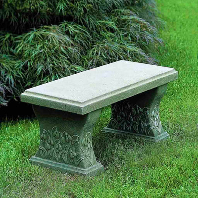 Campania International Snowdrop Bench, set in the garden to adding charm and purpose. The bench is shown in the English Moss Patina.