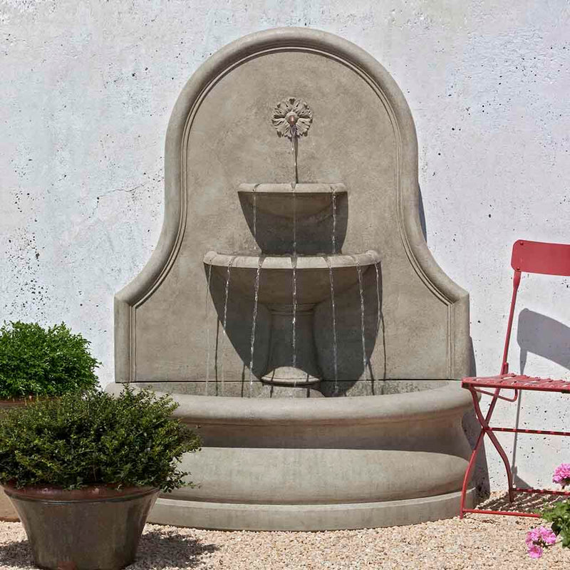 Campania International Estancia Wall Fountain, adding interest to the garden with the sound of water. This fountain is shown in the Verde Patina.