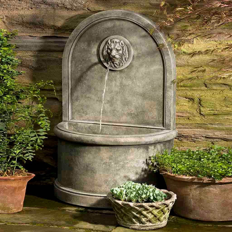Campania International Lion Wall Fountain, adding interest to the garden with the sound of water. This fountain is shown in the Alpine Stone Patina.