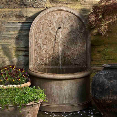 Campania International Corsini Wall Fountain, adding interest to the garden with the sound of water. This fountain is shown in the Aged Limestone Patina.