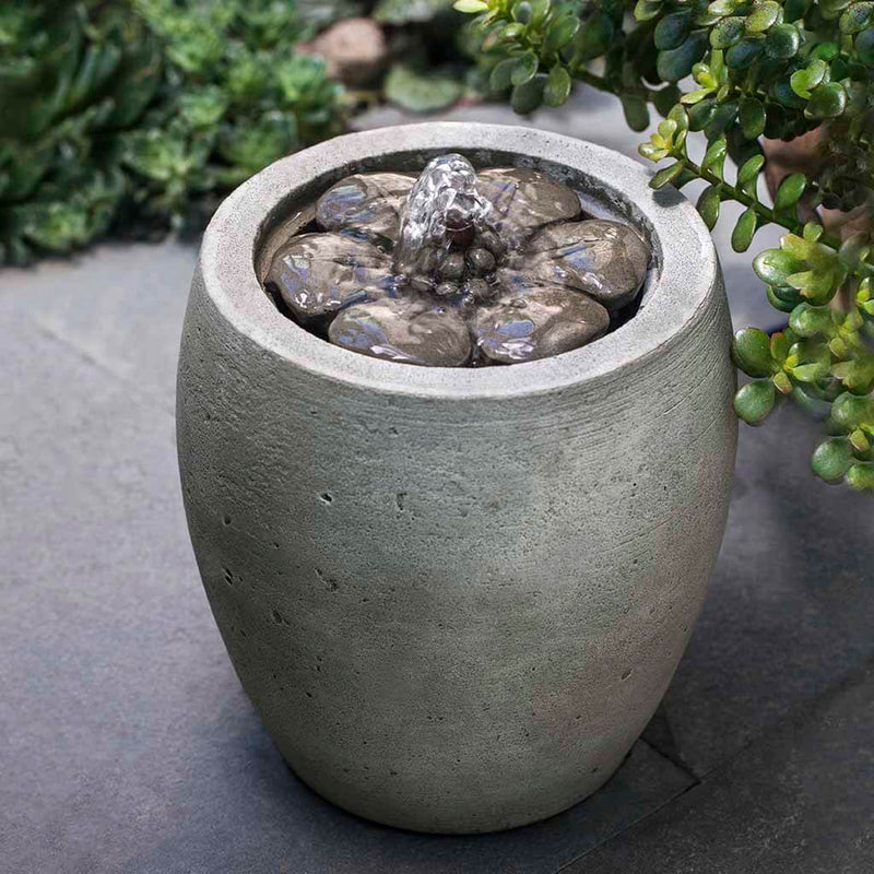 Campania International M-Series Camellia Fountain, adding interest to the garden with the sound of water. This fountain is shown in the Alpine Stone Patina.