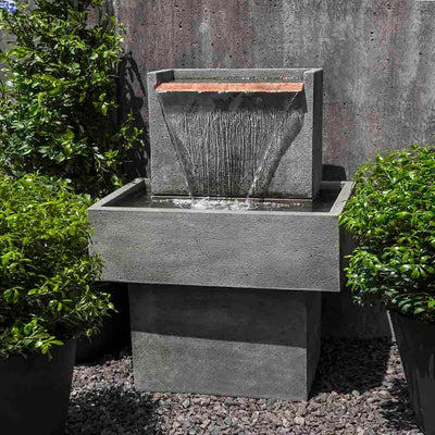 Campania International Falling Water Fountain I, adding interest to the garden with the sound of water. This fountain is shown in the Alpine Stone Patina.