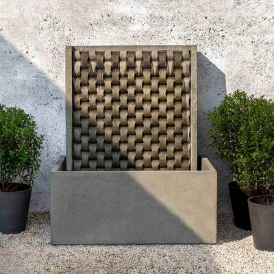 Campania International Large M Weave Fountain, adding interest to the garden with the sound of water. This fountain is shown in the Alpine Stone Patina.