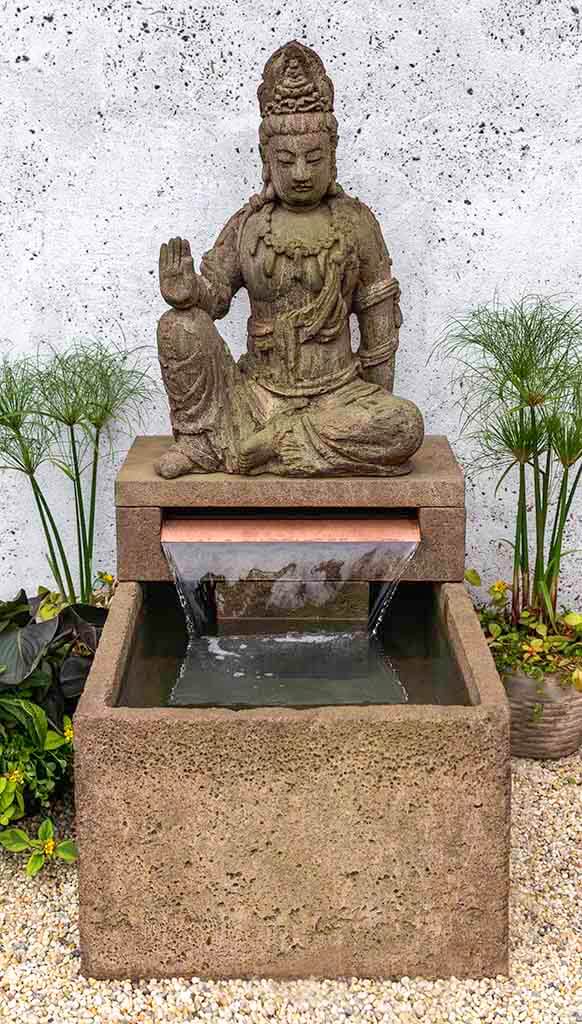 Campania International Antique Quan Yin Buddha Fountain, adding interest to the garden with the sound of water. This fountain is shown in the Aged Limestone Patina.