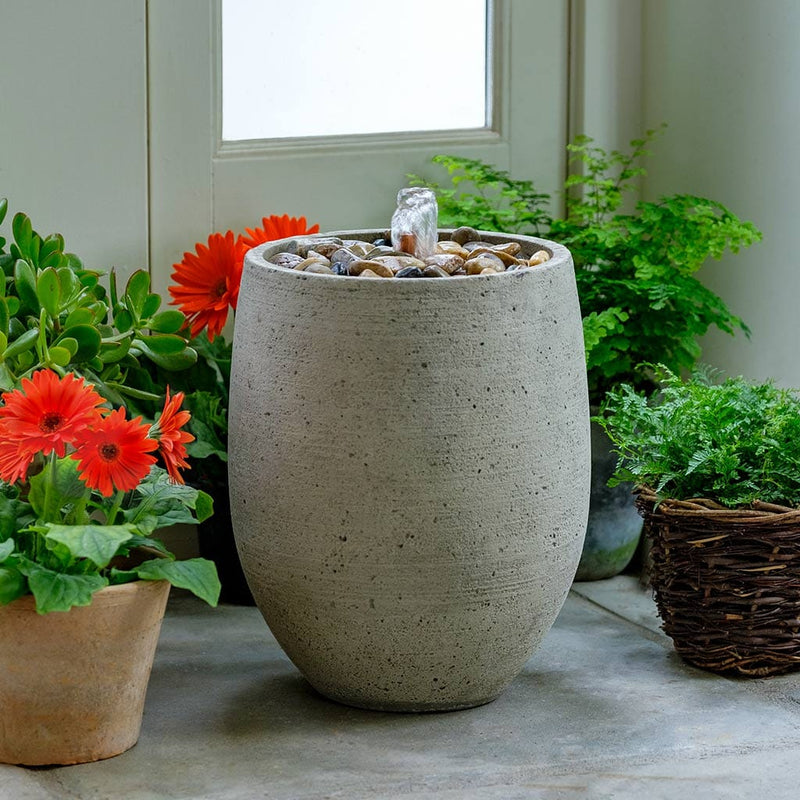 Campania International Bebel Pebble Fountain is made of cast stone by Campania International and shown in the Greystone Patina