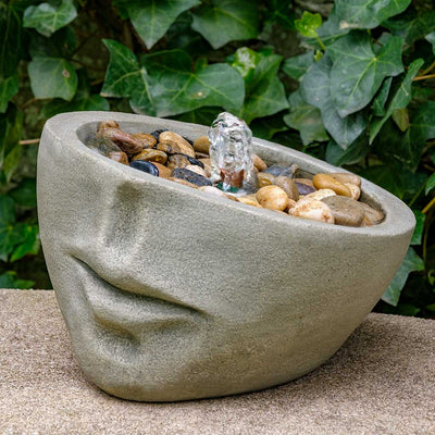 Campania International Faccia Fountain is made of cast stone by Campania International and shown in the Greystone Patina