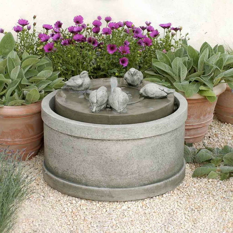 Campania International Passaros Fountain is made of cast stone by Campania International and shown in the Greystone Patina