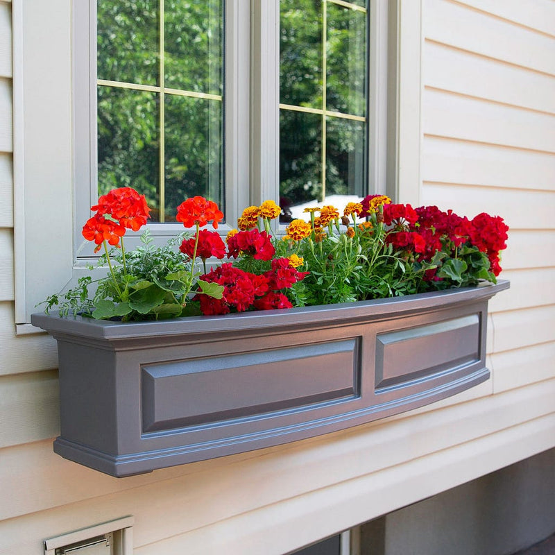 The Mayne Nantucket 4ft Window Box Planter, in the graphite finish,planted and mounted on home for curb appeal