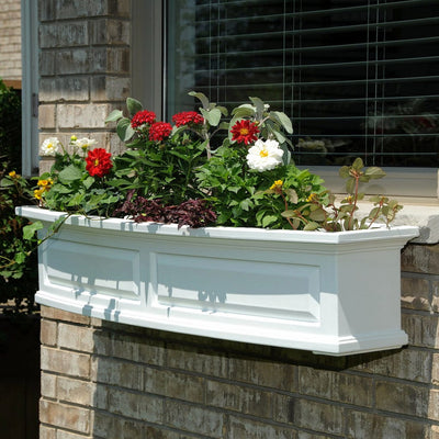 The Mayne Nantucket 4ft Window Box Planter, in the white finish, planted and mounted on home for curb appeal