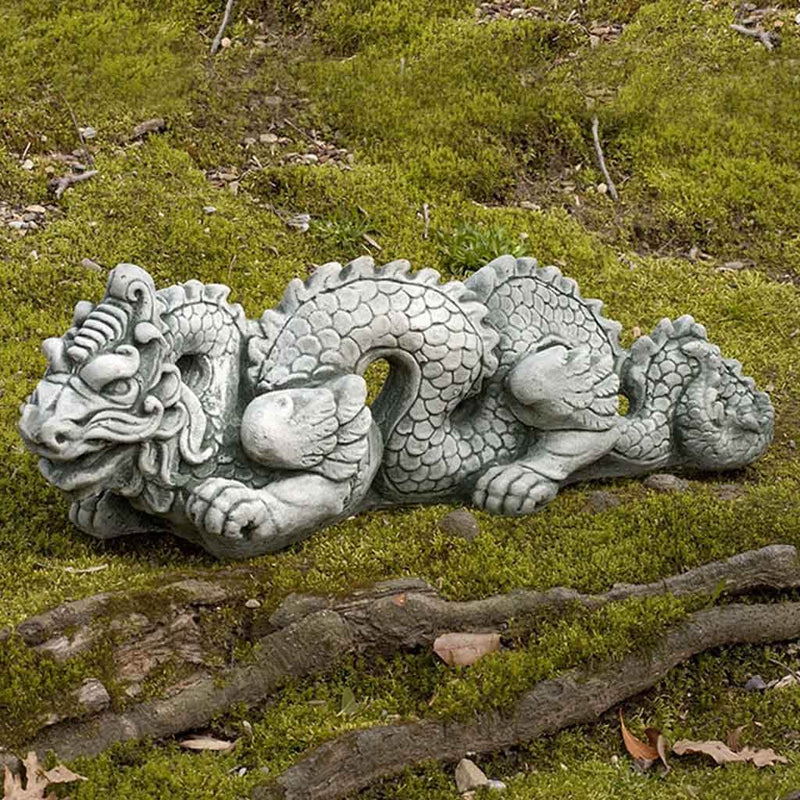 Campania International Small Dragon, set in the garden to adding charm an meaning. The statue is shown in the Greystone Patina.