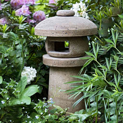 Campania International Sapporo Lantern, set in the garden to adding charm an meaning. The statue is shown in the Brownstone Patina.