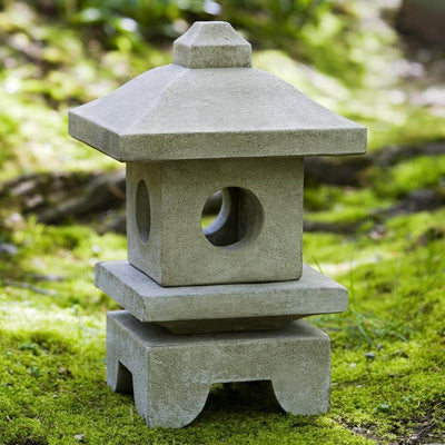 Campania International Katsura Lantern, set in the garden to adding charm an meaning. The statue is shown in the Verde Patina.