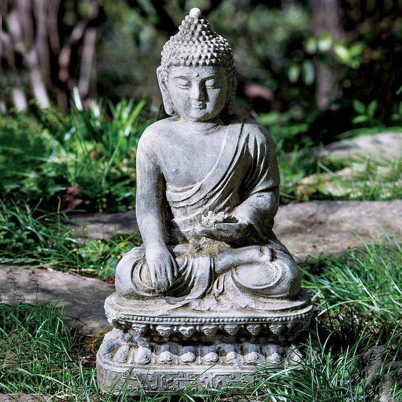 Campania International Seated Lotus Buddha Statue, set in the garden to adding charm an meaning. The statue is shown in the Alpine Stone Patina.
