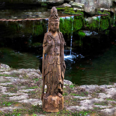 Campania International Quan Yin Garden Statue, set in the garden to adding charm an meaning. The statue is shown in the Pietra Nuova Patina.