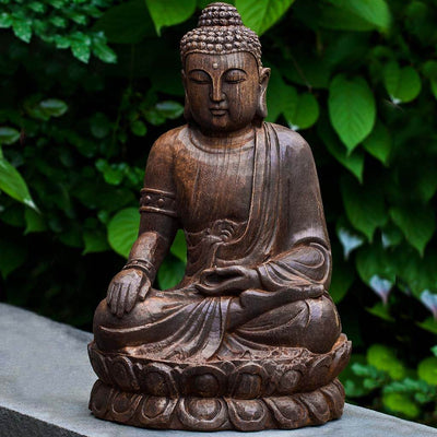 Campania International Antique Lotus Buddha Statue, set in the garden to adding charm an meaning. The statue is shown in the Pietra Nuova Patina.