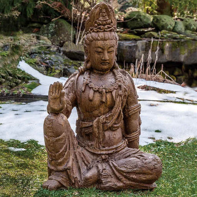 Campania International Antique Quan Yin Buddha Statue, set in the garden to adding charm an meaning. The statue is shown in the Pietra Nuova Patina.