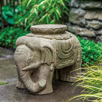 Campania International Artifact Elephant Statue, set in the garden to adding charm an meaning. The statue is shown in the Aged Limestone Patina.