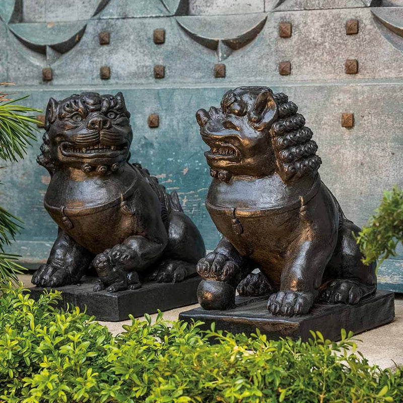 Campania International Traditional Foo Dog Statue Set, set in the garden to adding charm an meaning. The statue is shown in the Nero Nuovo Patina.