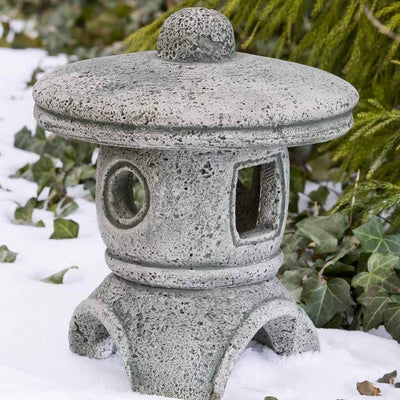 Campania International Rustic Medium Pagoda, set in the garden to adding charm an meaning. The statue is shown in the Alpine Stone Patina.