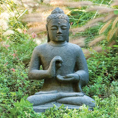 Campania International Indonesian Seated Buddha, set in the garden to adding charm an meaning. The statue is shown in the Nero Nuovo Patina.