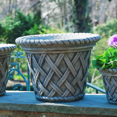 Campania International English Weave Large Planter is shown in the Alpine Stone Patina. Made from cast stone.